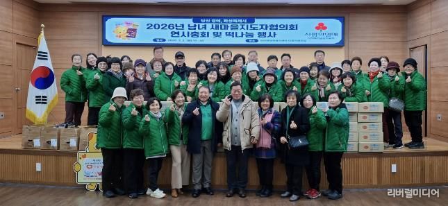 장안면 남녀 새마을지도자협의회와 장안면 주민들이 떡 나눔 행사를 기념하고 있다